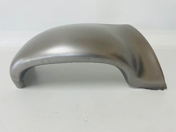 A curved, metal fender, likely for a vehicle, with a brushed metal finish against a white backdrop.
