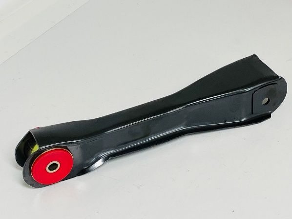 Black suspension control arm with a red bushing.