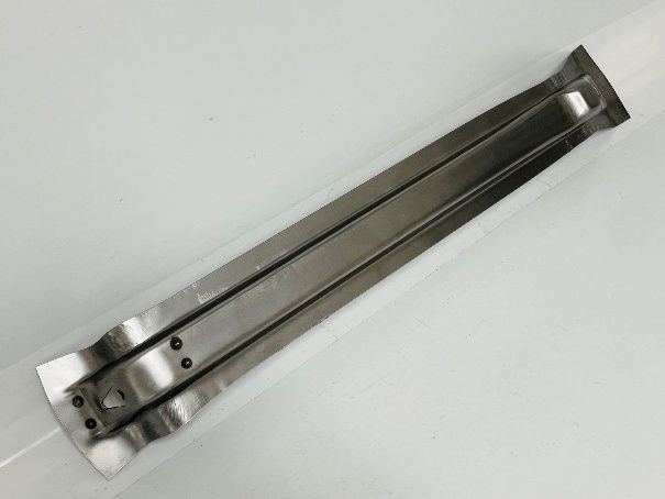 Two stainless steel strips, possibly for a part of a machine, in a clear plastic sleeve.