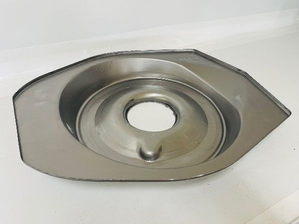 A silver metal part with an eye-shaped outer edge, a central hole, and concentric raised rings.