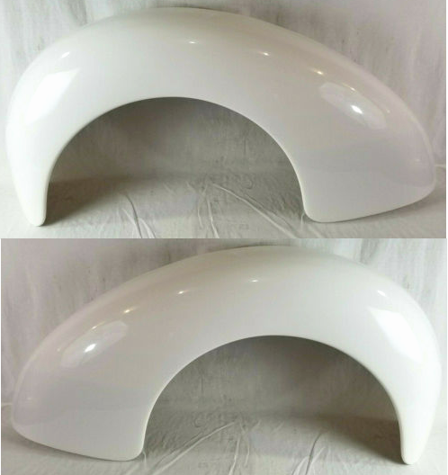 Two white fenders are sitting on a white surface.