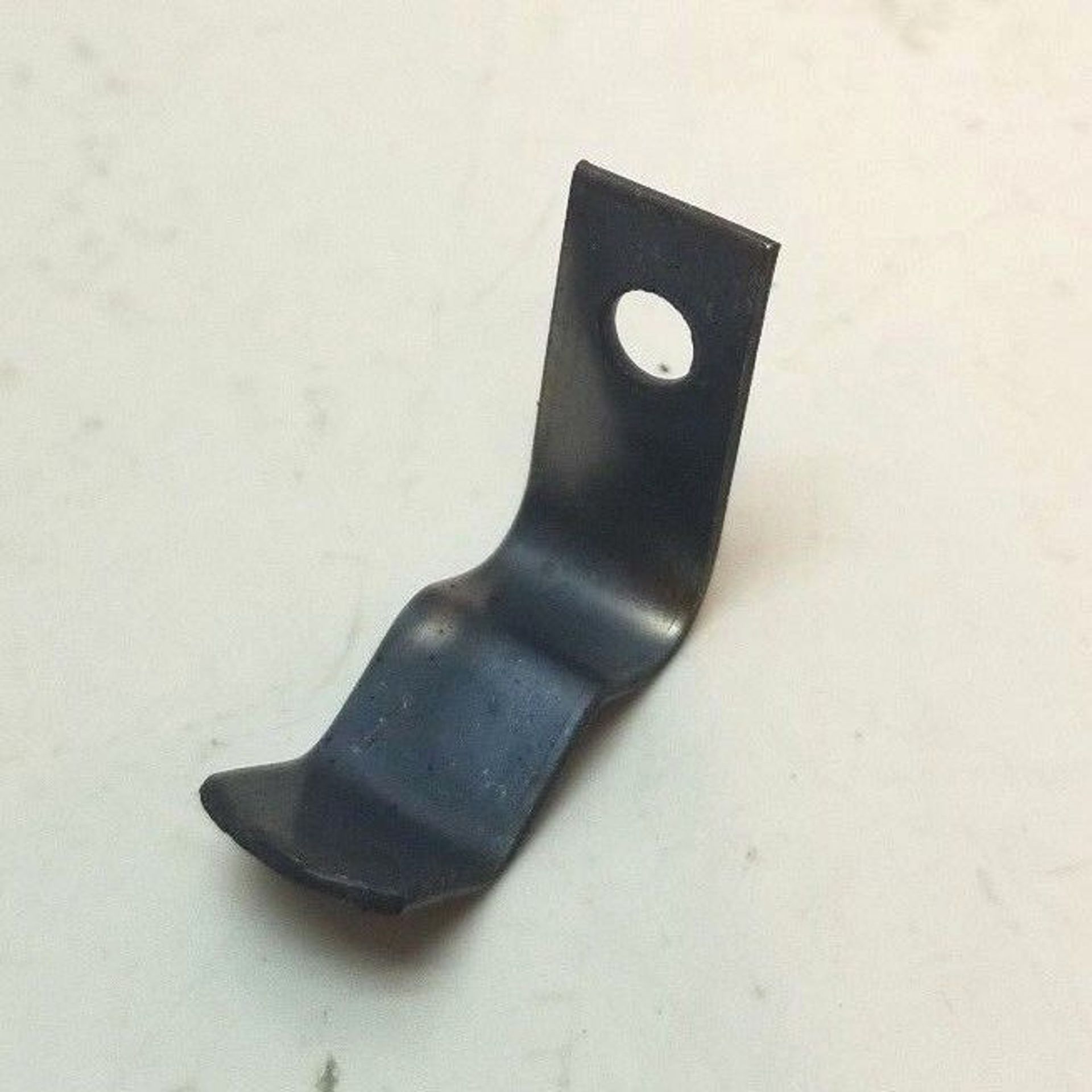 A small piece of metal with a hole in the middle