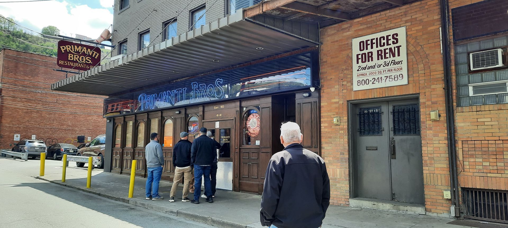 A group of people are standing outside of a building.
