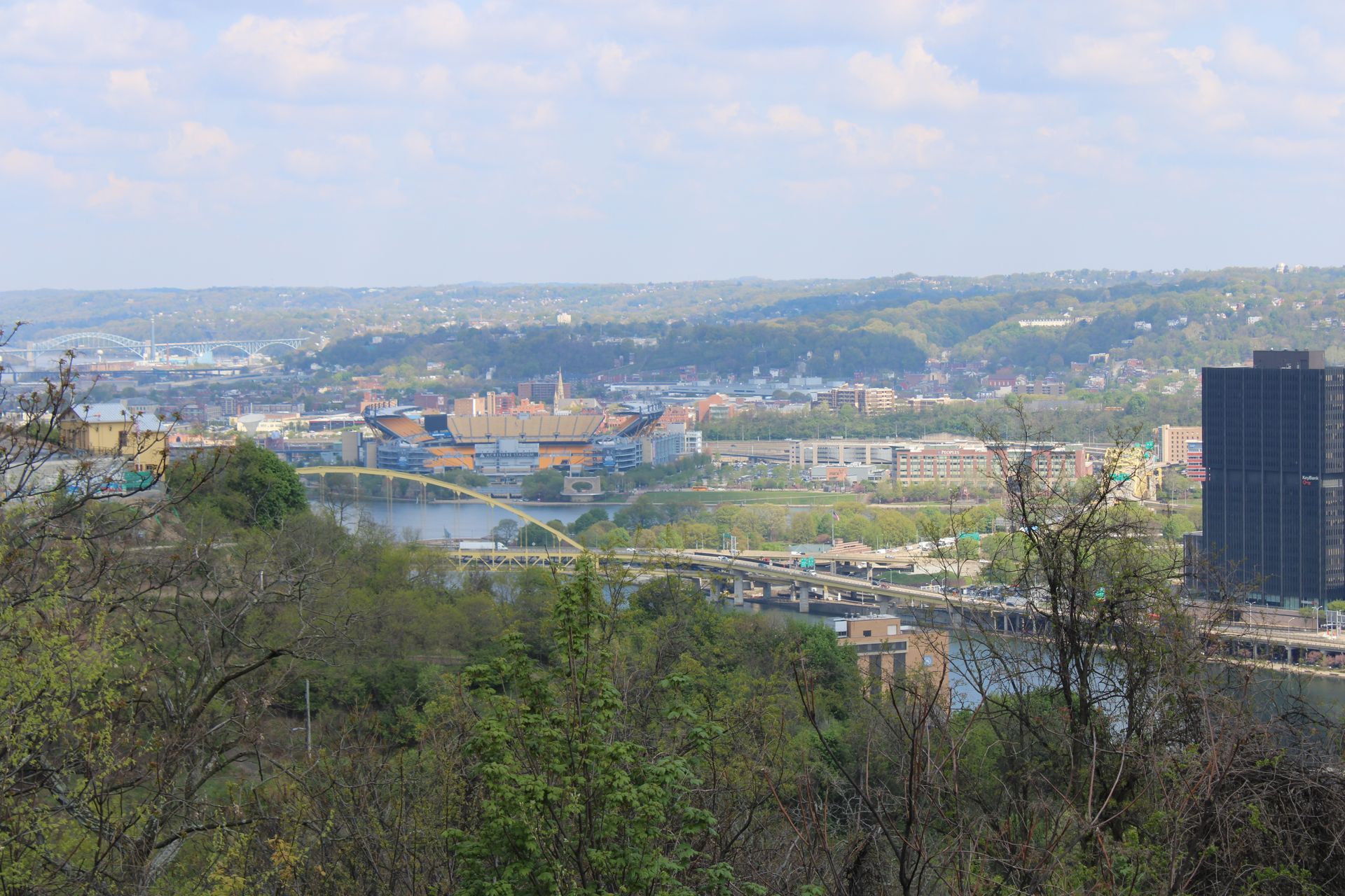 A view of a city from a hill overlooking a river.