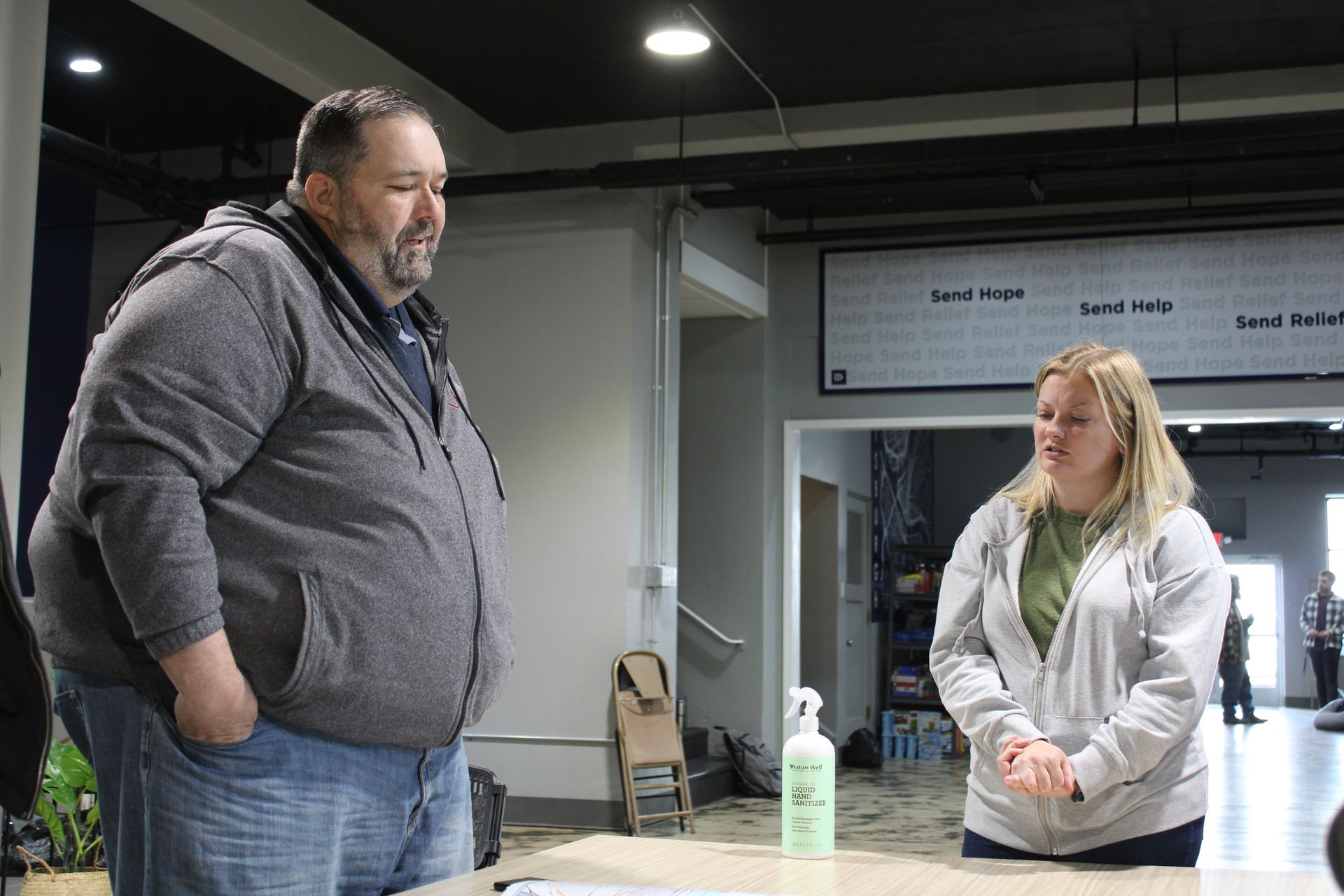 A man and a woman are standing next to each other in a room.