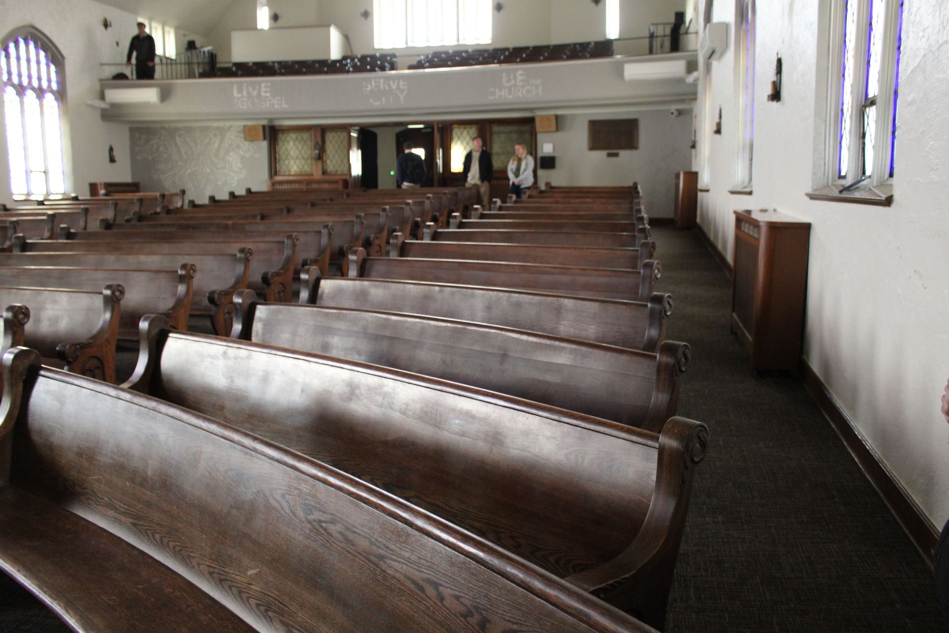 Rows of wooden benches in an empty church
