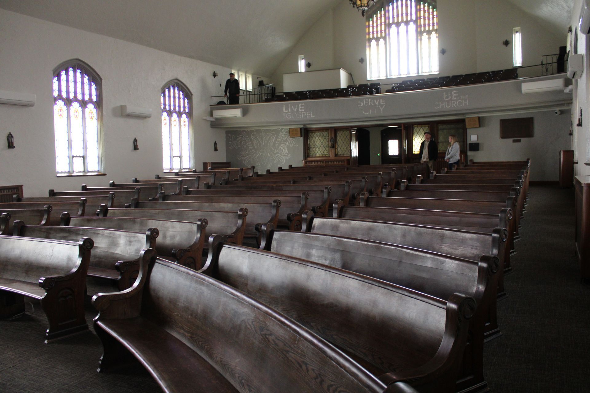 Rows of wooden benches in an empty church