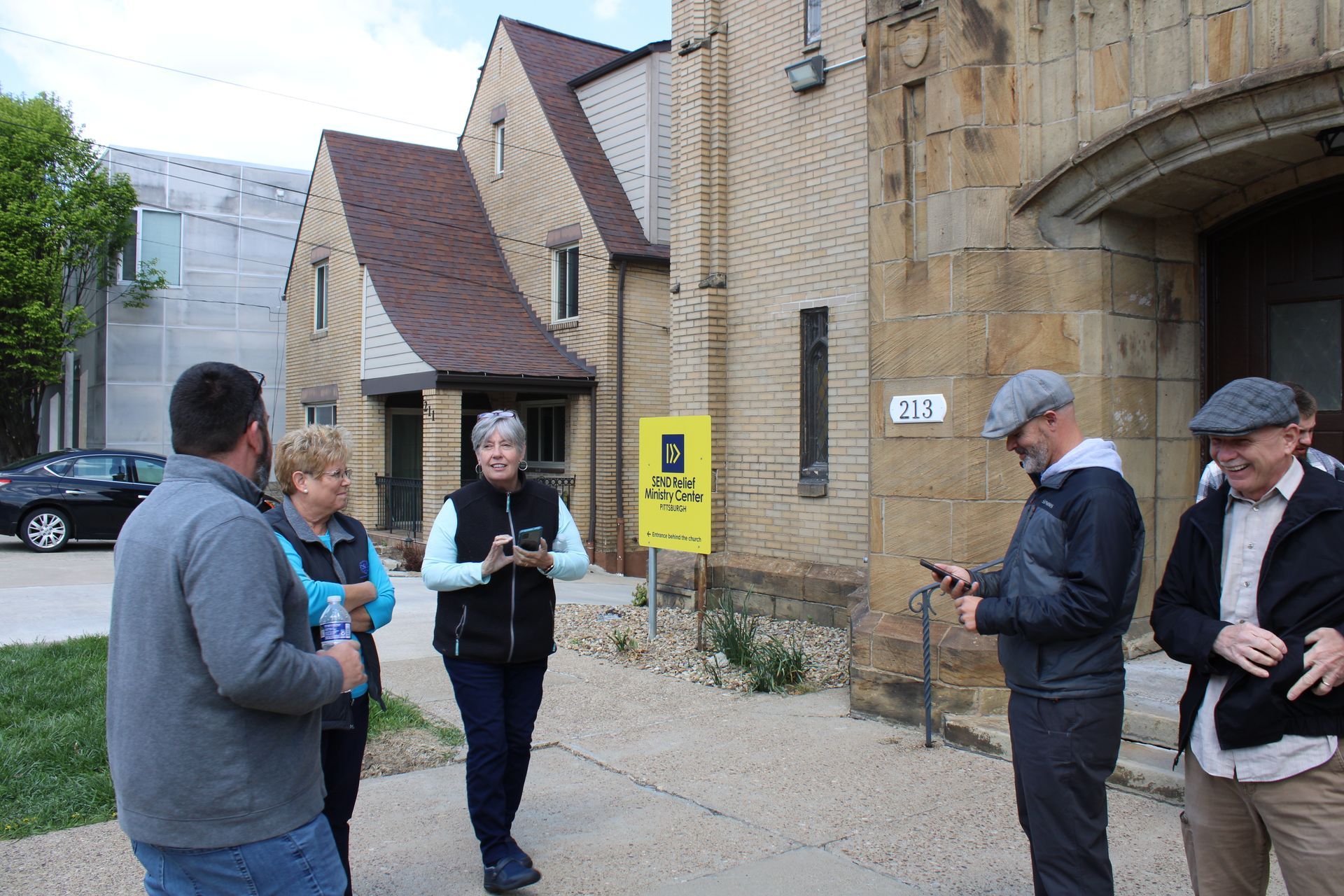 A group of people are standing outside of a building.