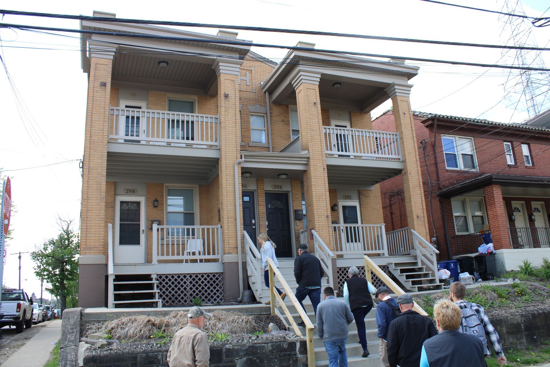 A group of people are walking up the stairs of a building