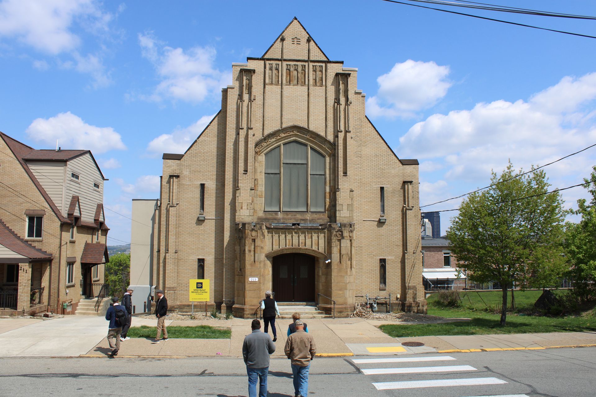 A group of people are walking in front of a church