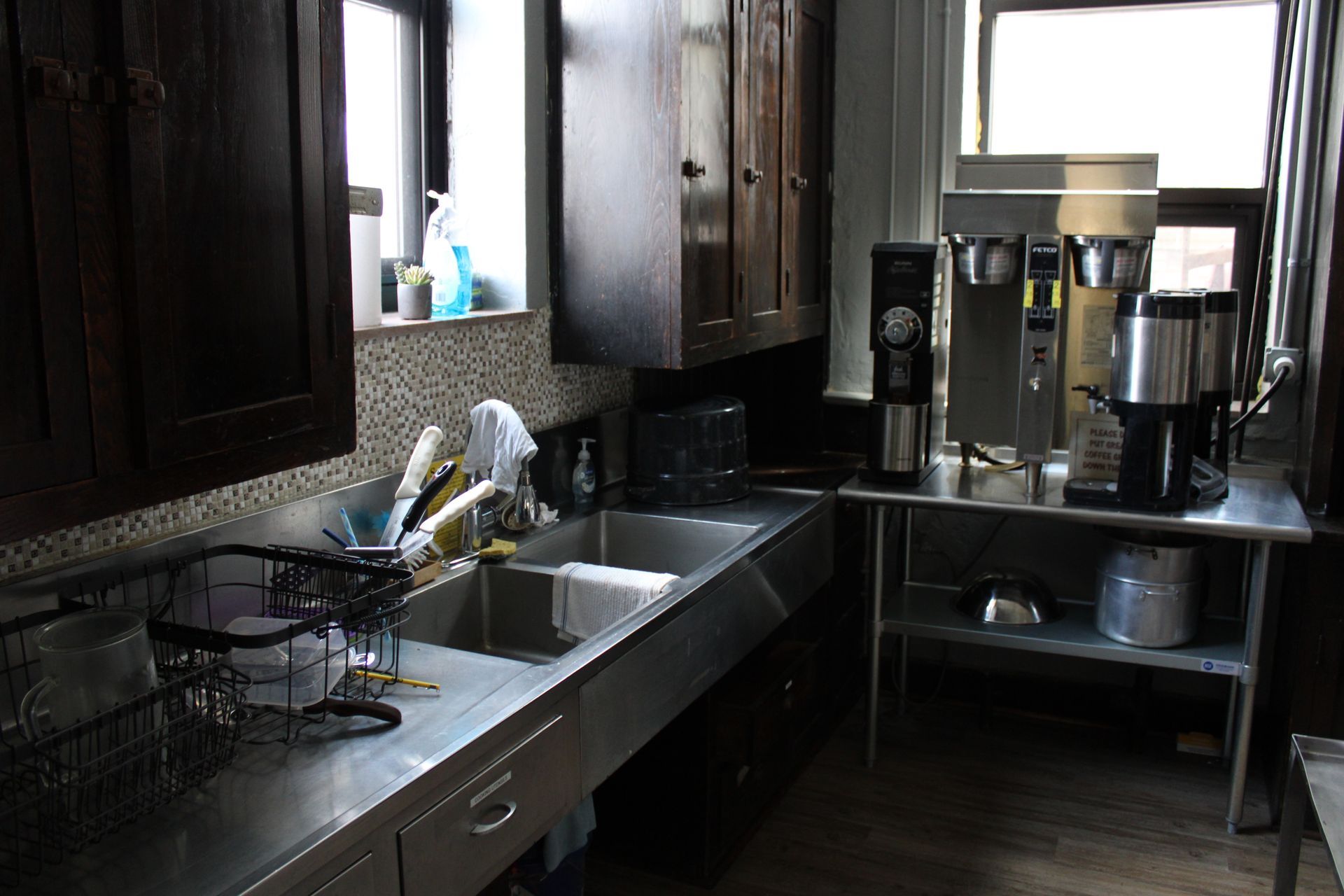 A kitchen with a sink and a coffee maker