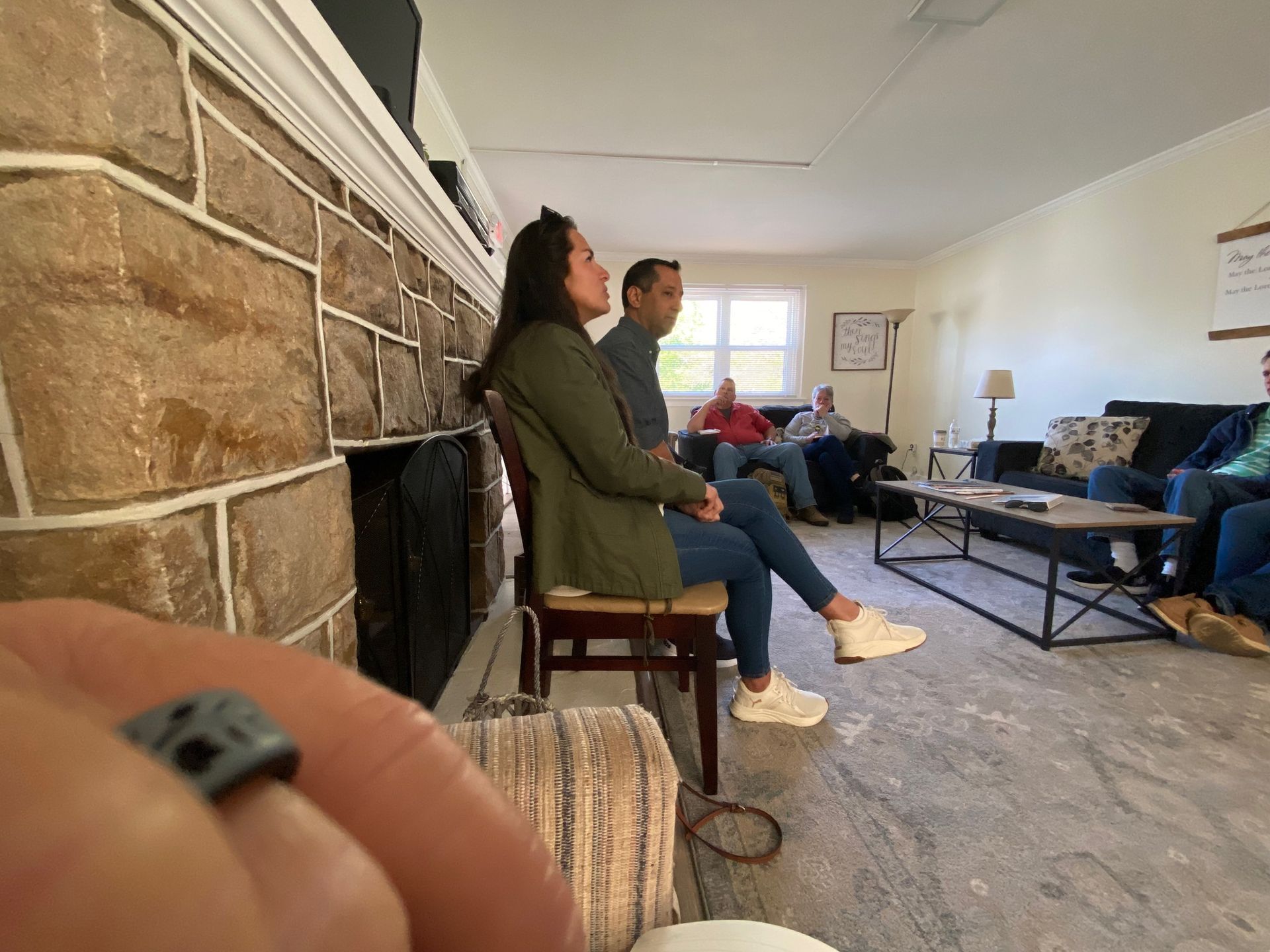 A group of people are sitting in a living room.