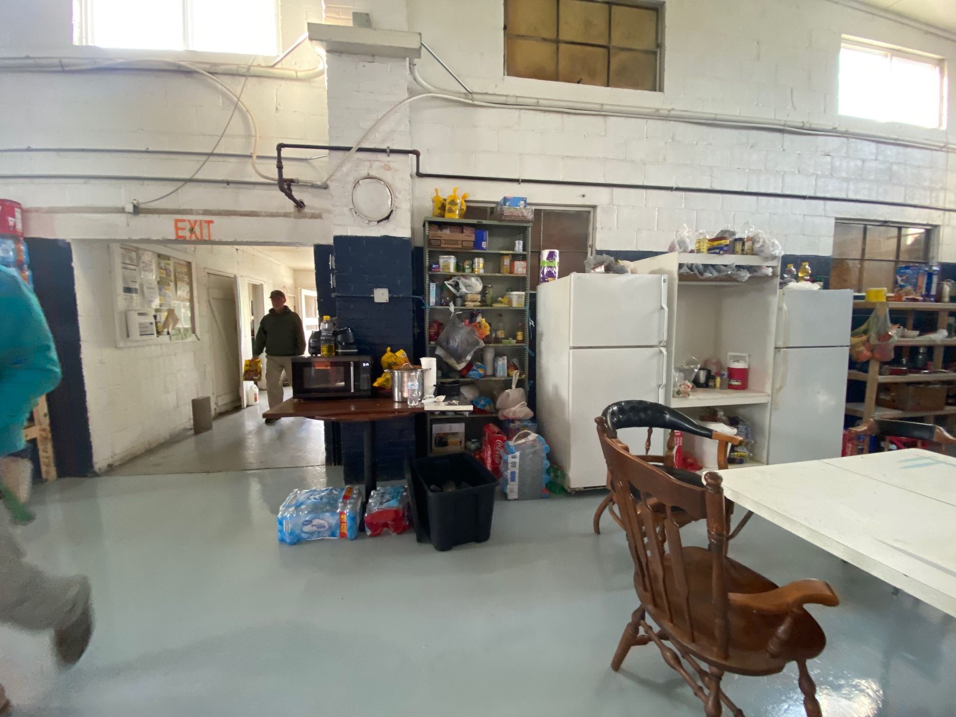 A large room with a lot of furniture and a refrigerator.