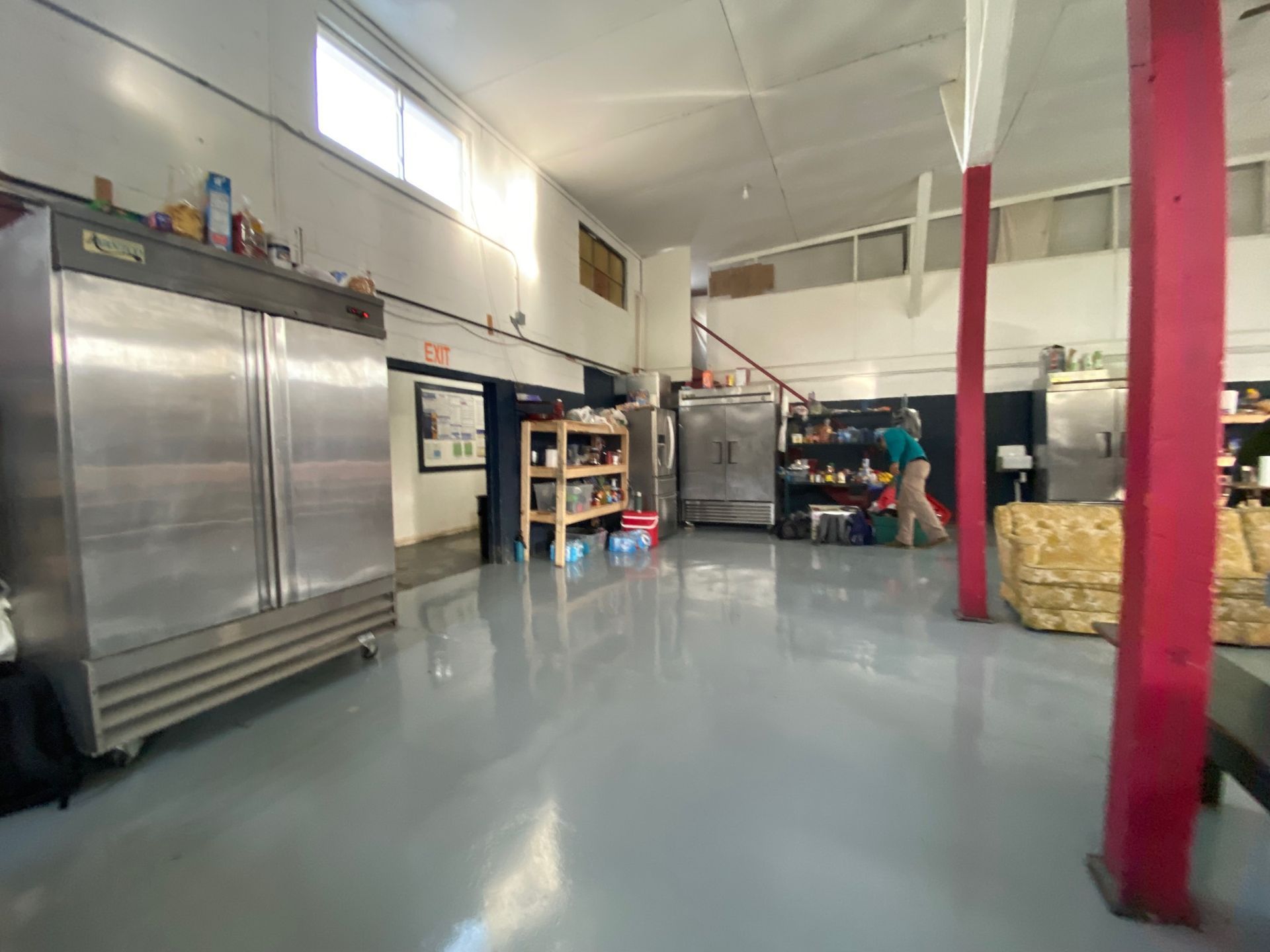 A large room with a lot of stainless steel appliances in it.