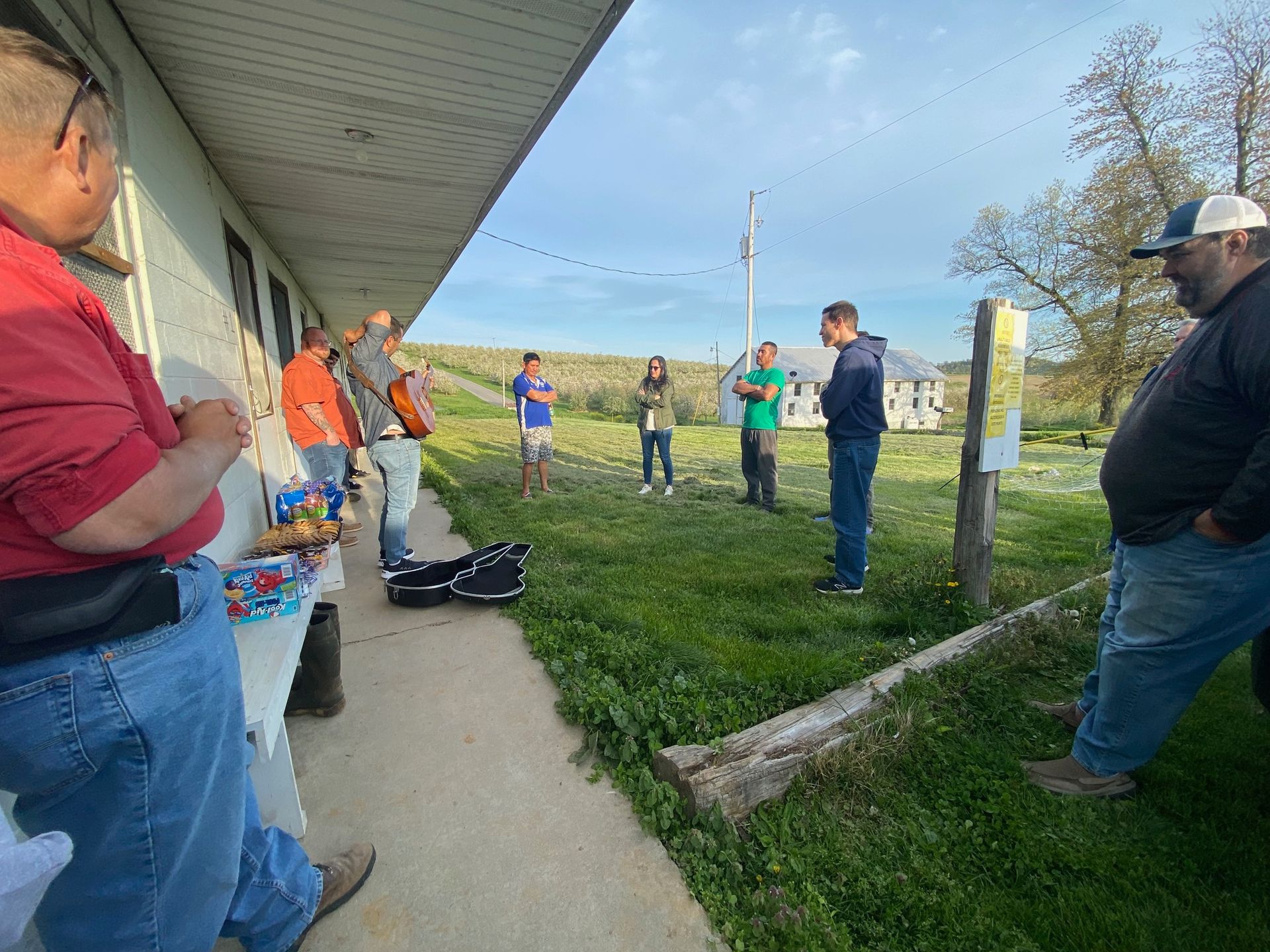 A group of people are standing outside of a building talking to each other.