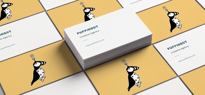 A stack of business cards with a picture of a Puffinbot on them.
