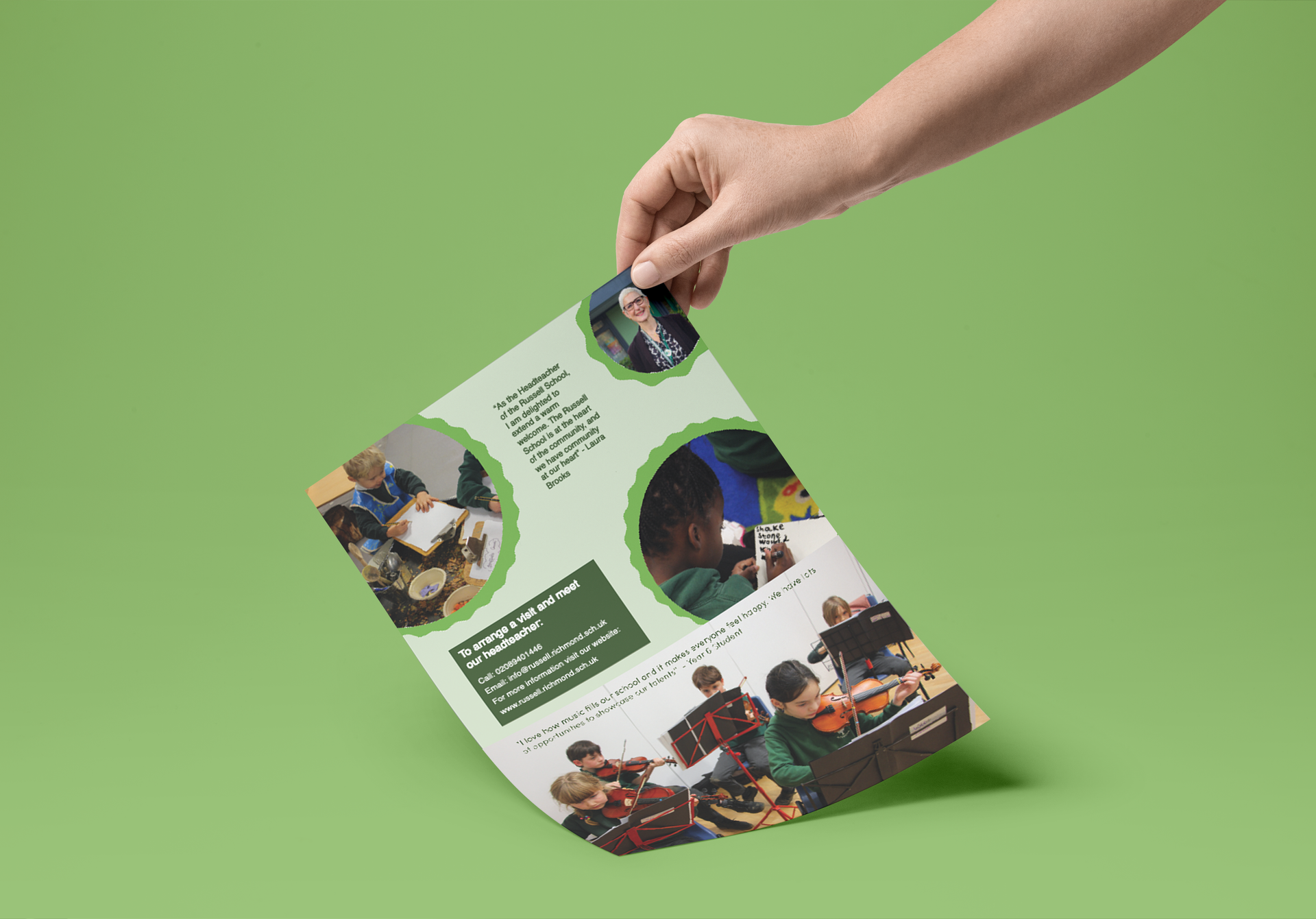 A person is holding a piece of paper with a picture of people on it.