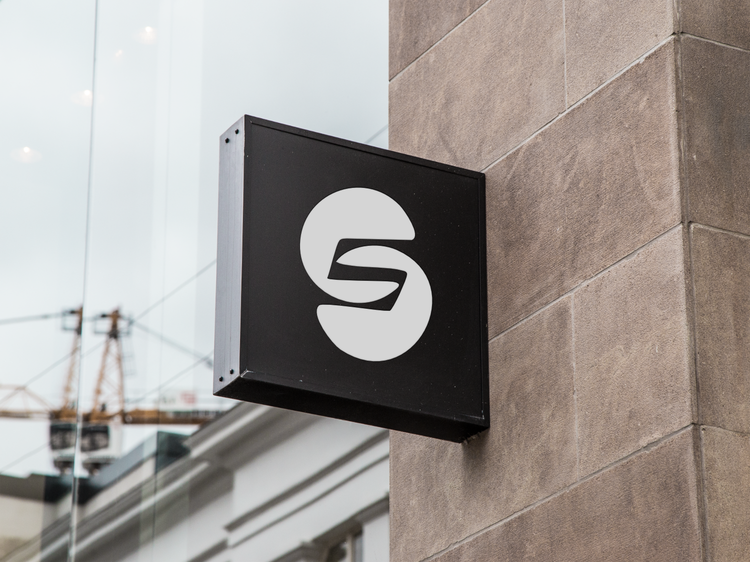 A black sign with the letter s on it for Sneak logo
