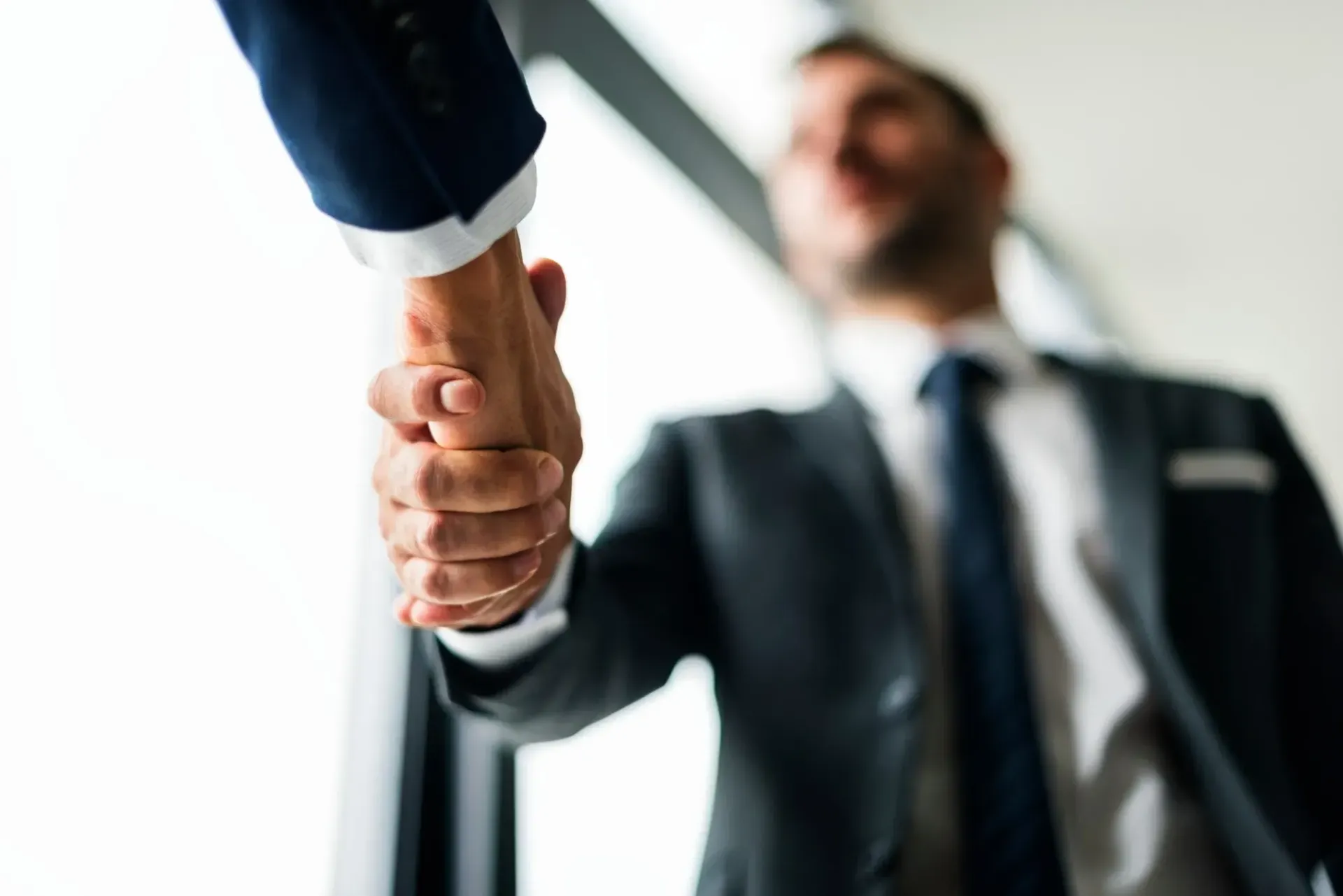 Business handshake confirming a new funding agreement