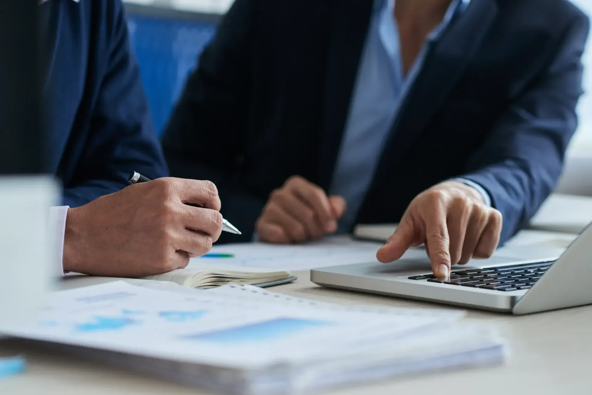 Business professionals reviewing funding figures on a laptop