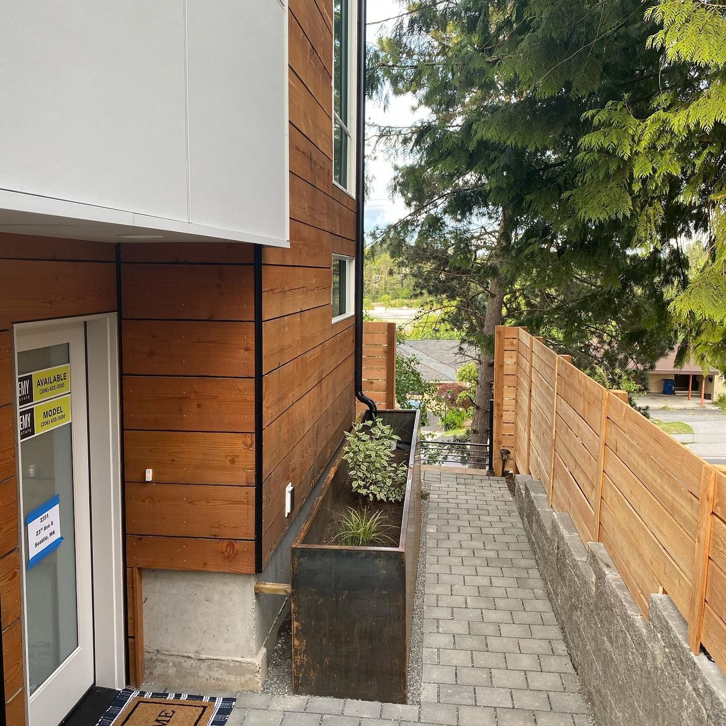 A brick walkway leading to the front door of a house