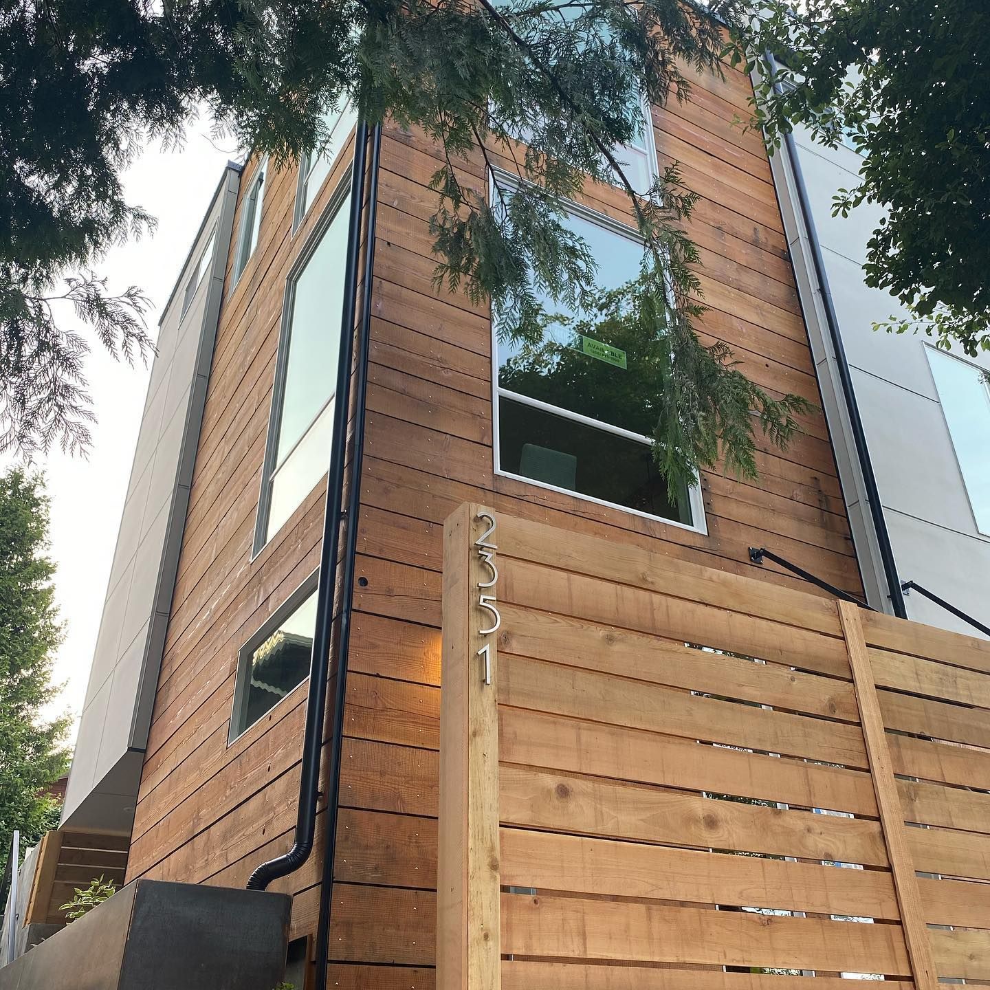 A house with a wooden fence in front of it