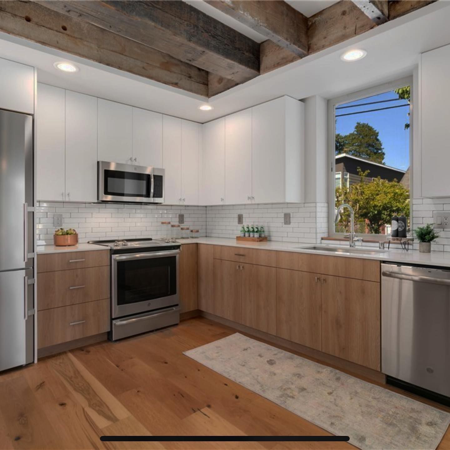 A kitchen with stainless steel appliances and wooden cabinets