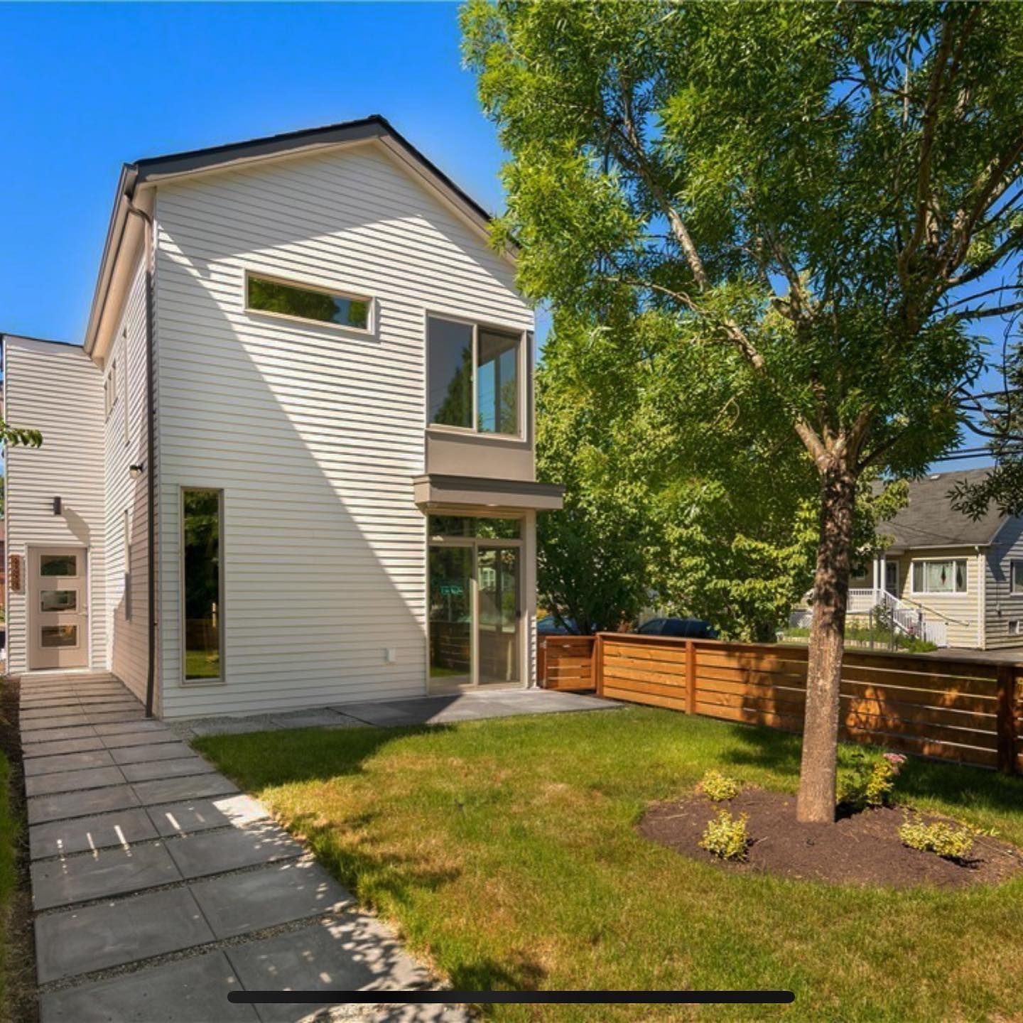 A white house with a wooden fence in front of it