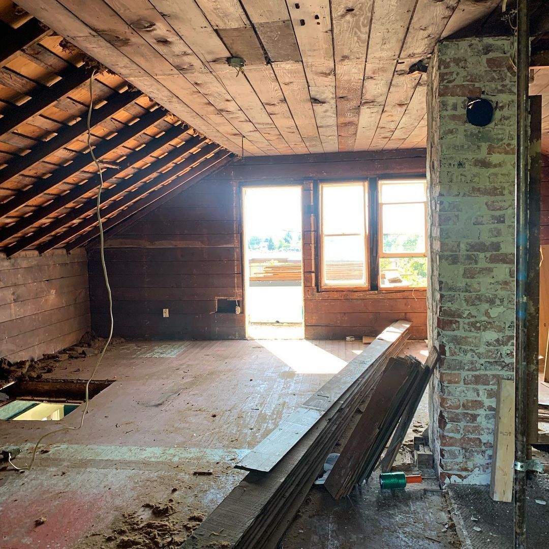 A room with a wooden ceiling and a brick chimney