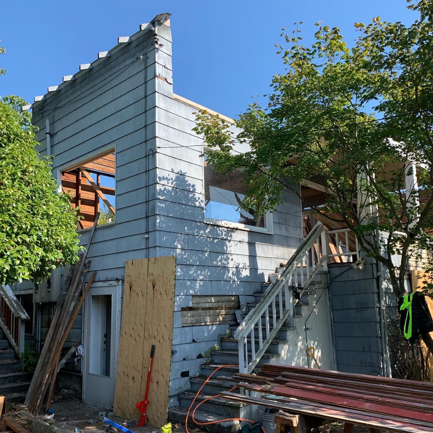 A house that is being remodeled with stairs and a wooden door