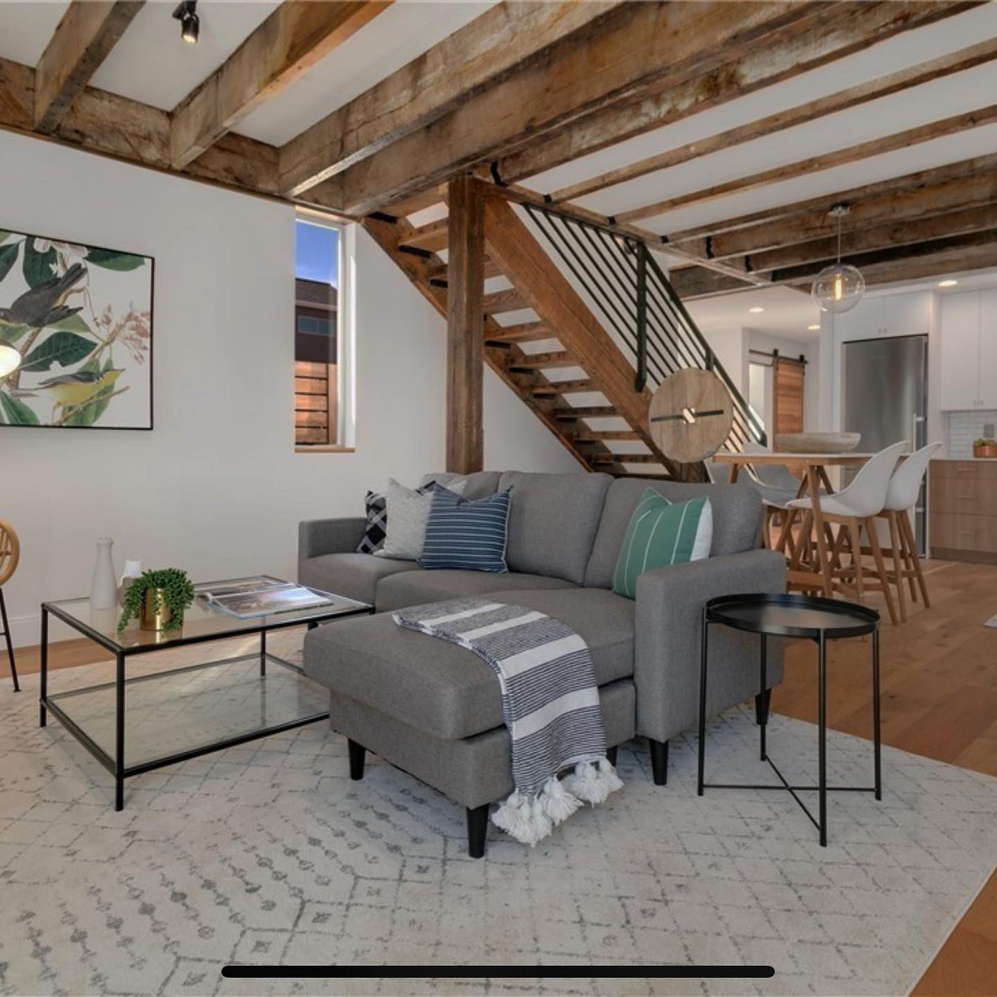 A living room with a couch and stairs in the background
