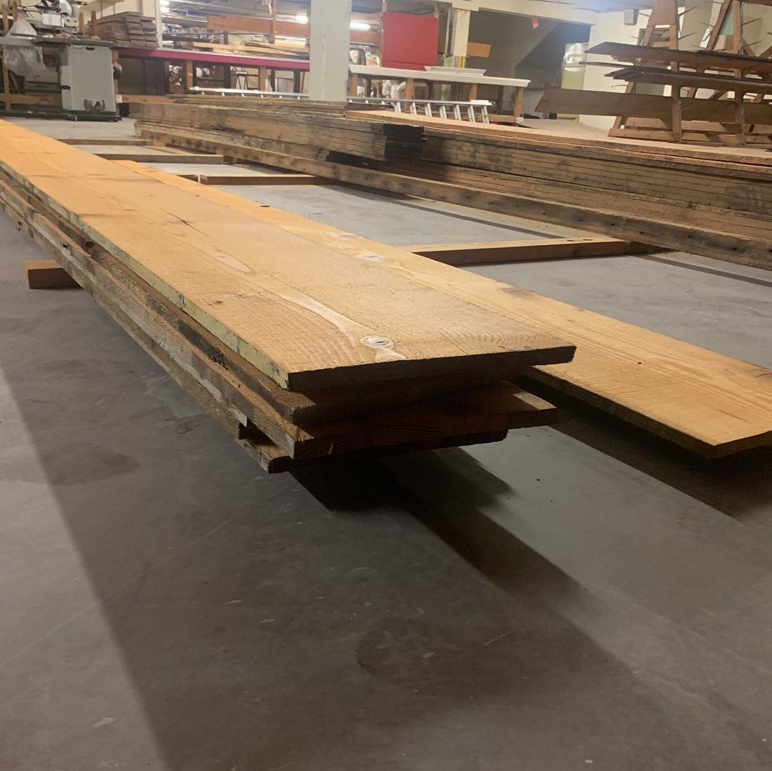 A stack of wood is sitting on the floor in a warehouse