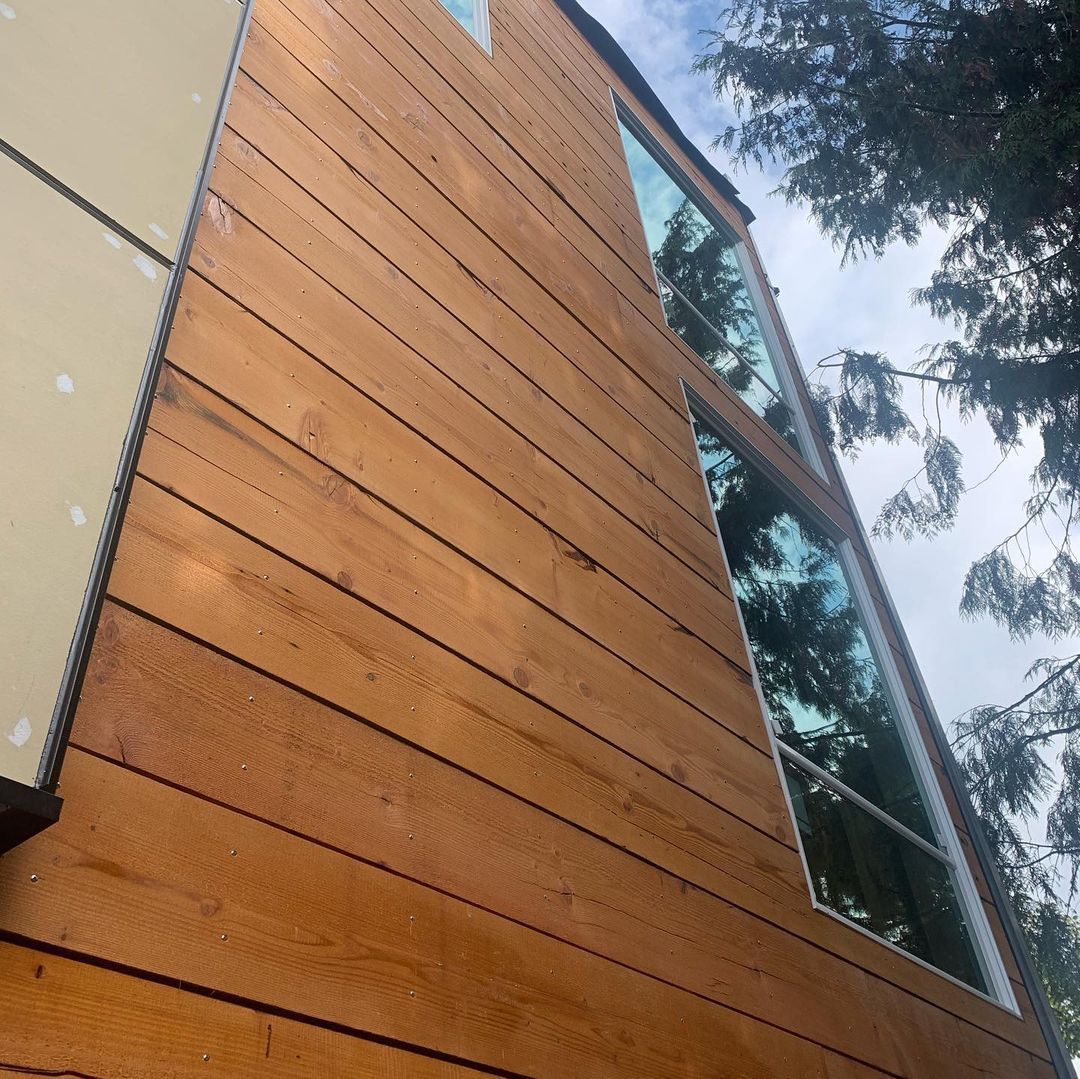 Looking up at a wooden building with lots of windows