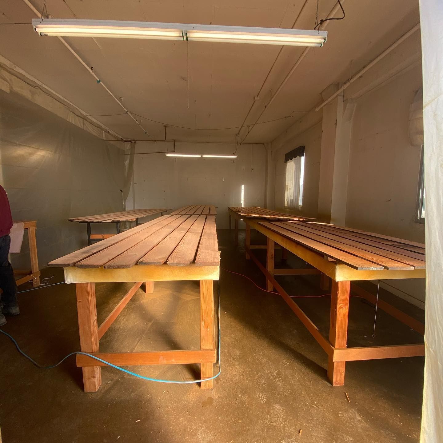 A room with a lot of wooden tables in it