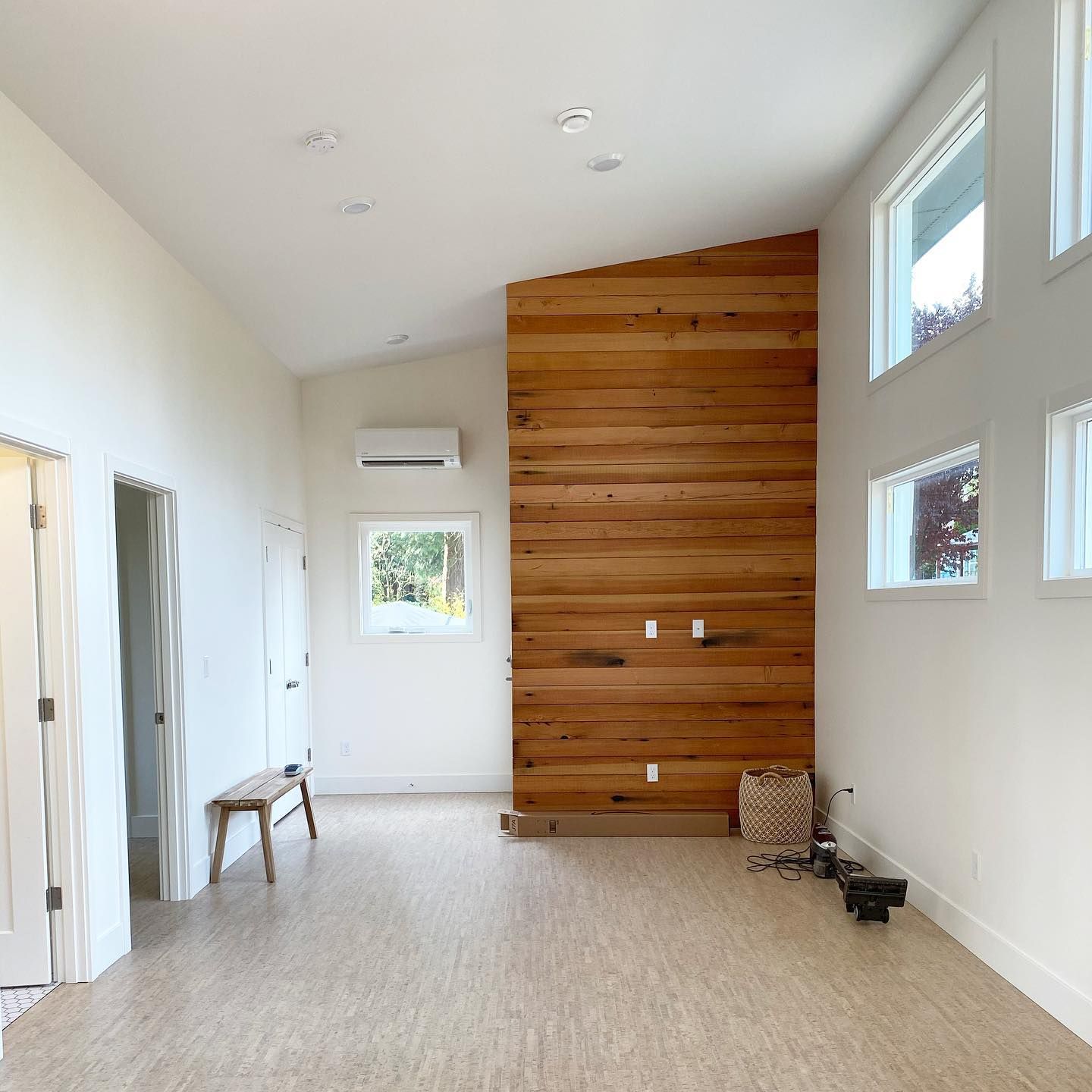 A large room with a wooden wall and lots of windows
