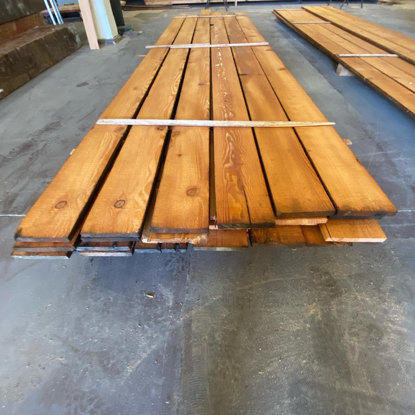 A stack of wooden boards sitting on a concrete floor