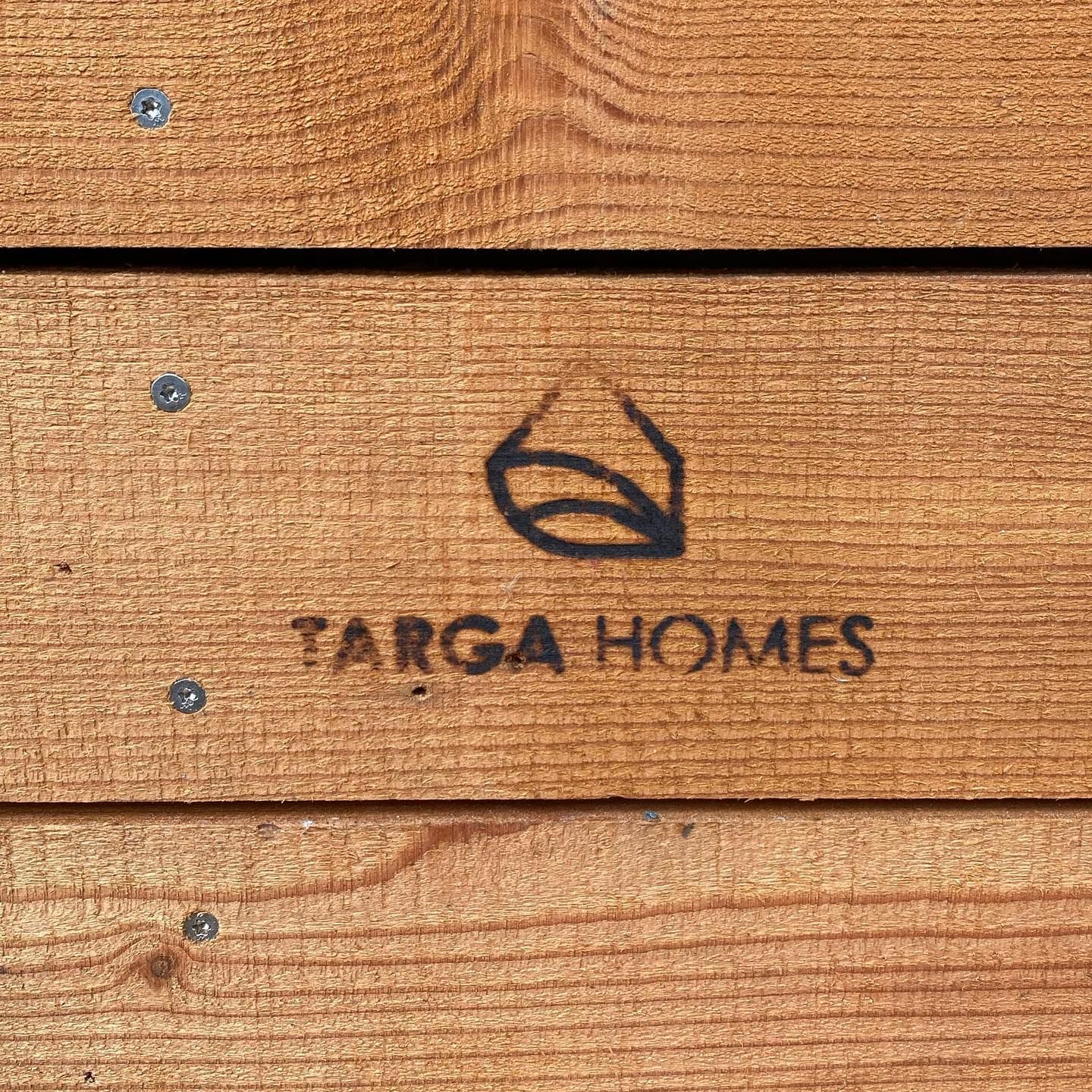 A piece of wood with targa homes written on it