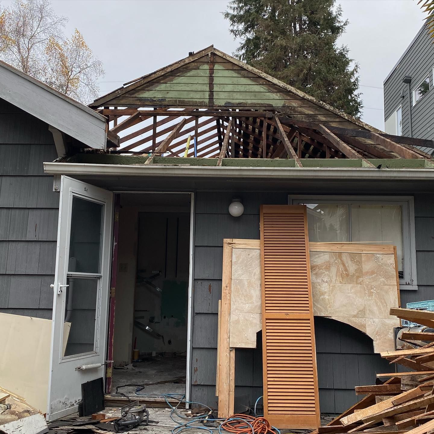A house with a green roof is being demolished.