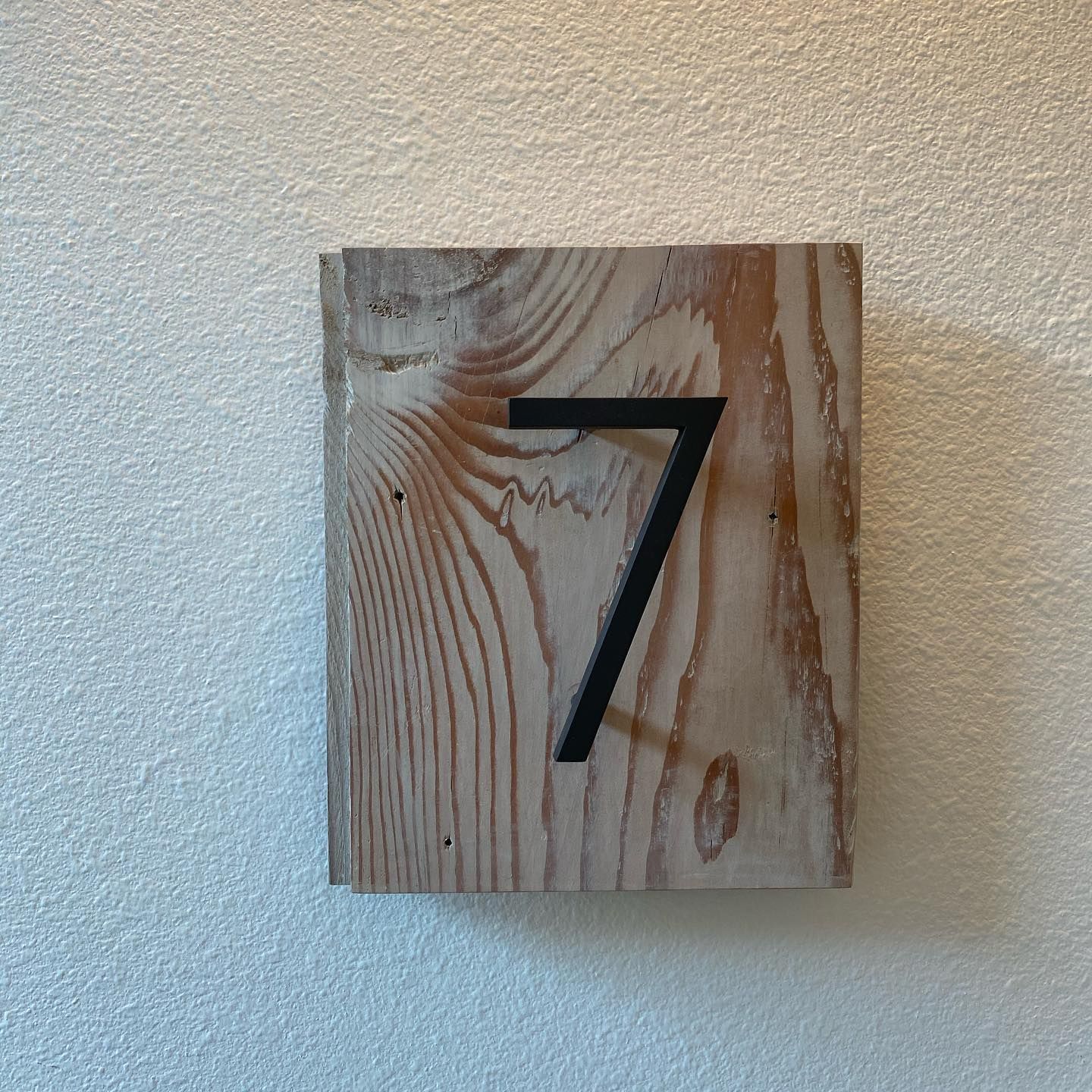 A wooden block with the number 7 on it