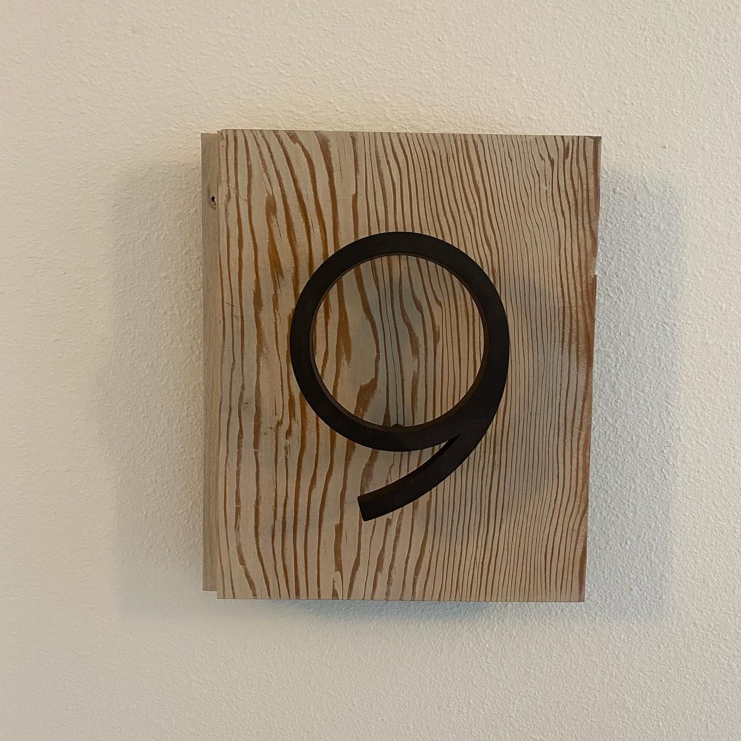 A wooden block with the number 9 on it