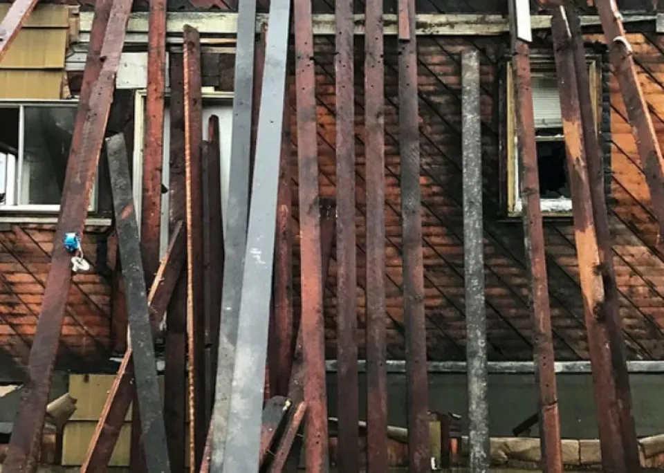 A bunch of wooden beams are stacked on top of each other