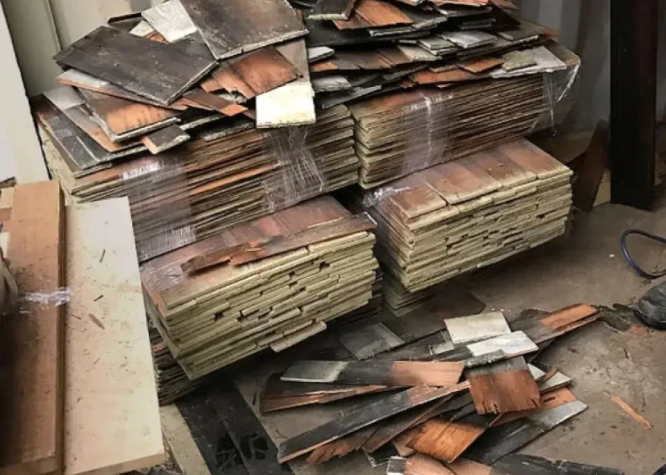 A pile of cardboard boxes stacked on top of each other on the floor.