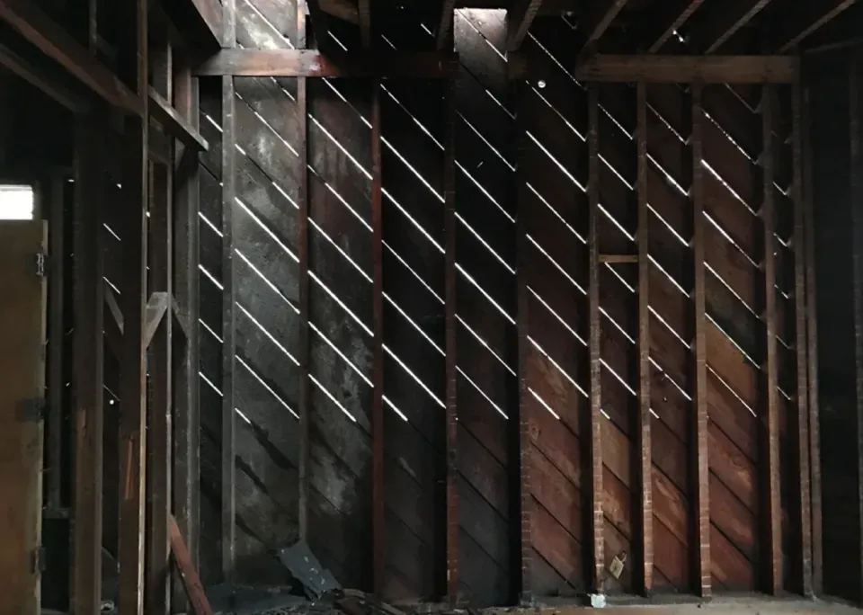 A wooden wall with a pattern of diagonal lines on it