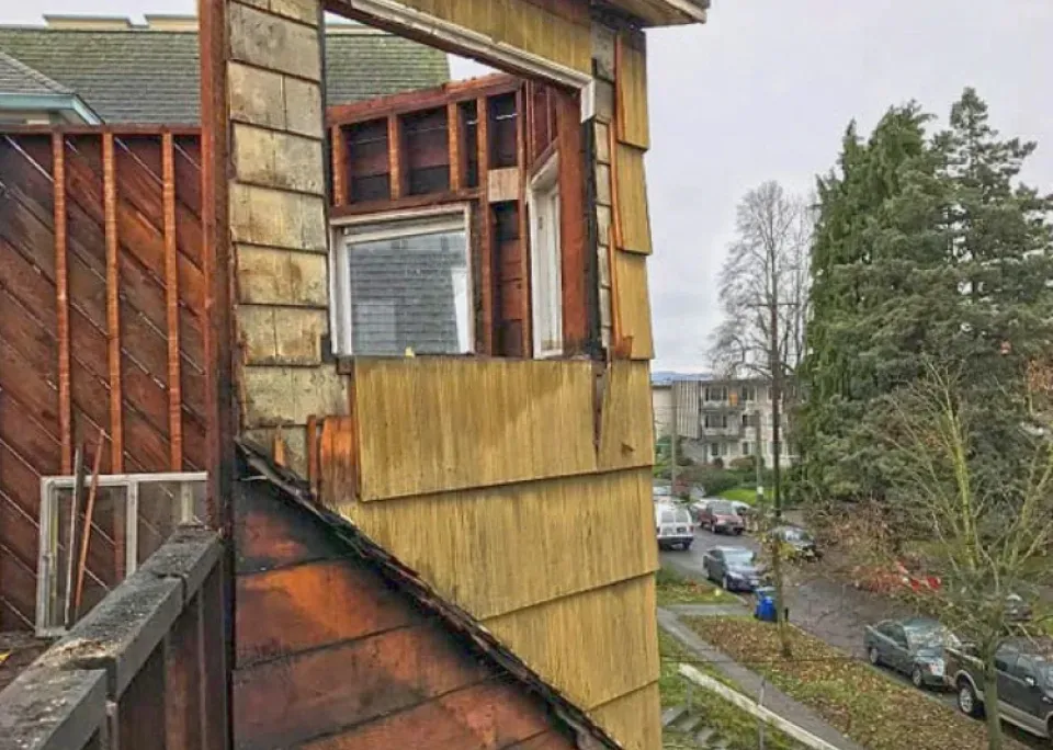 A house with a window missing from the side of it.