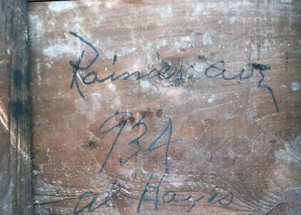 A close up of a piece of wood with writing on it
