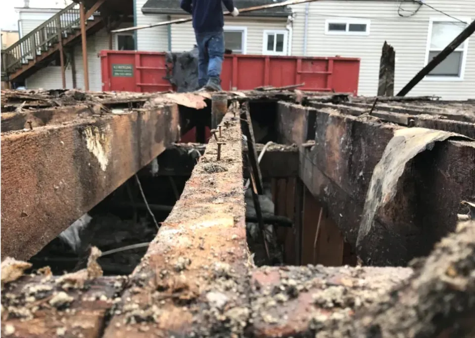A man is standing on top of a wooden structure.