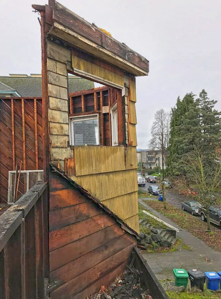 A wooden building with a window on the side of it.