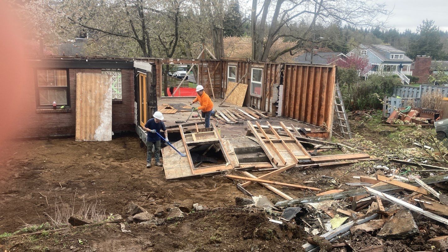 A group of people are working on a house that is being demolished.