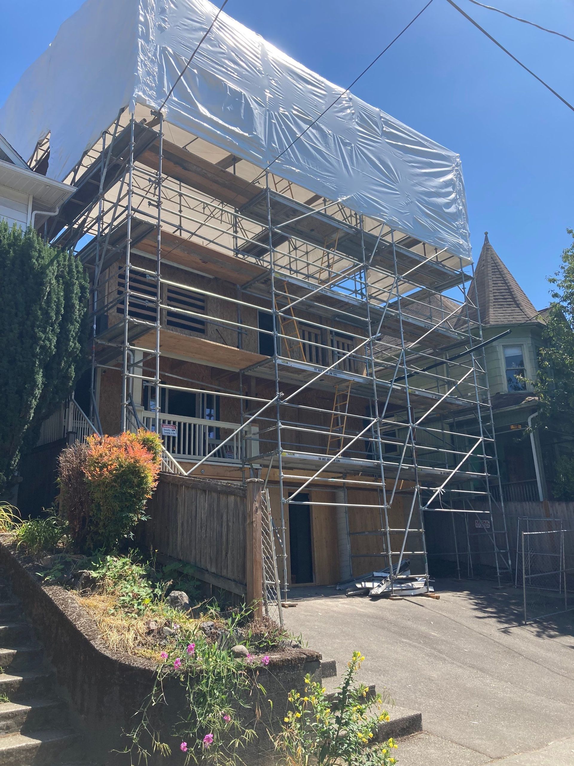 A house is being remodeled with scaffolding around it.