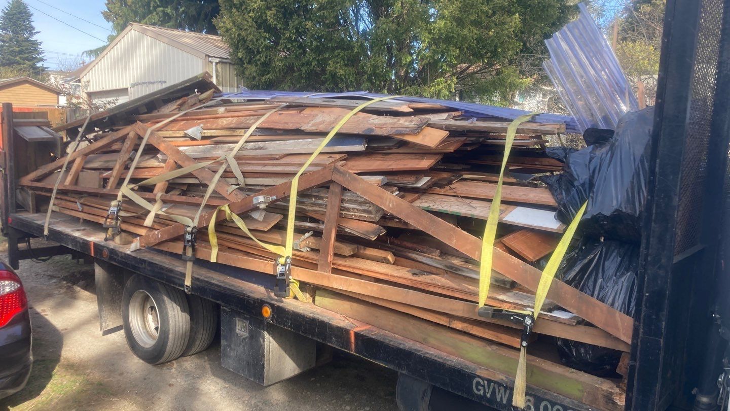 A truck is carrying a large pile of wood.